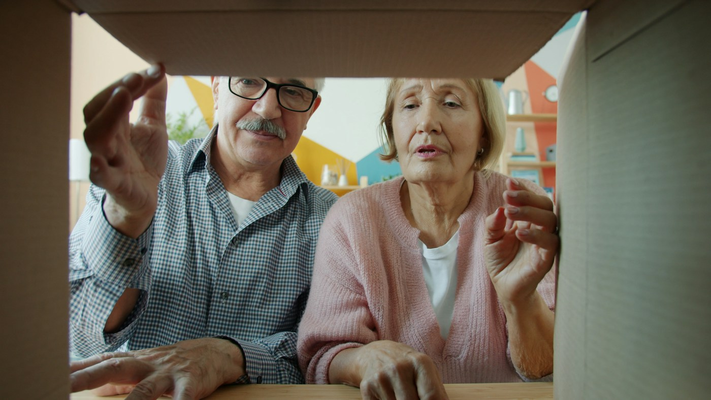 Older couple opening a box together