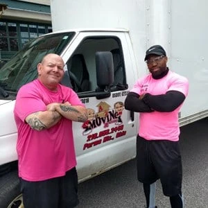 Zak and Larry beside an A to Z moving truck in a company archive photo